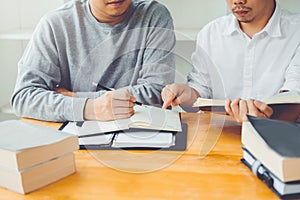 High school or college students studying and reading together in library