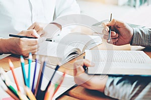 High school or college students studying and reading together in library