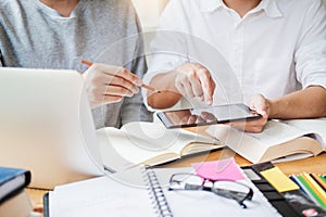 High school or college students studying and reading together in library