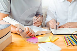 High school or college students studying and reading together in library