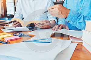 High school or college students studying and reading together in library Reading Research School Concept