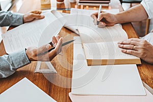 High school or college students studying and reading together in library Reading Research School Concept