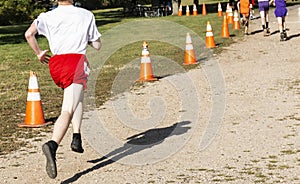 High school cross country runner chasing the leader to the finish line