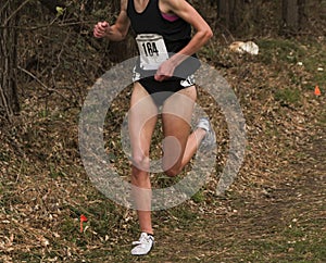 High School female running in a cross country race