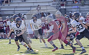 High School Football Players Run With The Ball