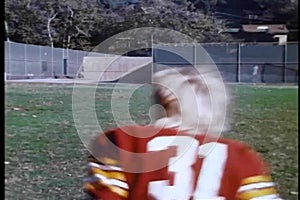 High school football team and coach running across field