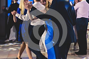 High school graduates dancing waltz and classical ball dance in dresses and suits on school prom graduation, classical ballroom photo