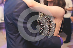 High school graduates dancing waltz and classical ball dance in dresses and suits on school prom graduation, classical ballroom