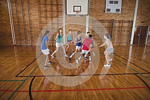 High school kids playing basketball in the court