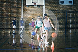 High school kids practicing football using cones for dribbling drill