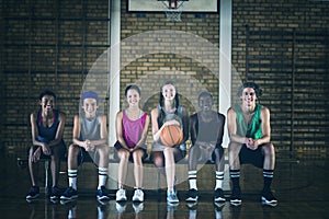 High school kids sitting on a bench in basketball court