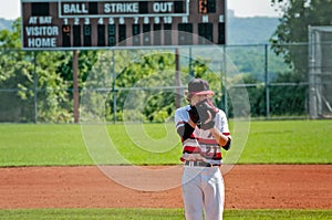 High school pitcher looking for signals from catcher.