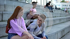 High school pupil getting acquainted pretty red-haired female romantic feelings photo