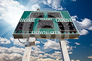 High School Scoreboard Over Blue Sky with Clouds photo