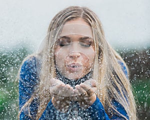 High school senior poses for portraits blowing glitter