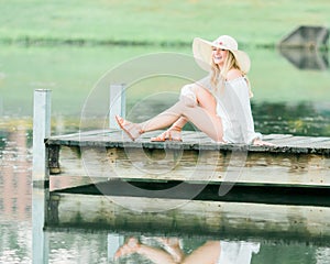 High school senior poses for portraits on dock