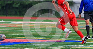 High school soccer player chasing the ball during a game