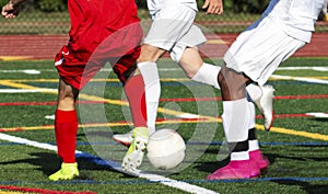 High school soccer players fighting for possession of the ball photo