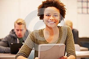High School Student At Desk In Class Using Digital Tablet