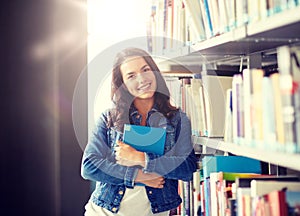 High school student girl reading book at library