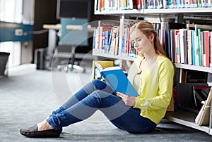 High school student girl reading book at library