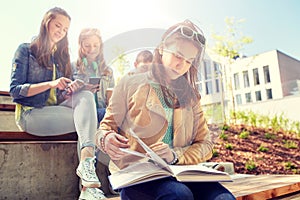 High school student girl reading book outdoors