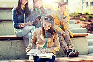 High school student girl reading book outdoors