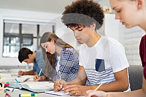 High school student guy studying in classroom