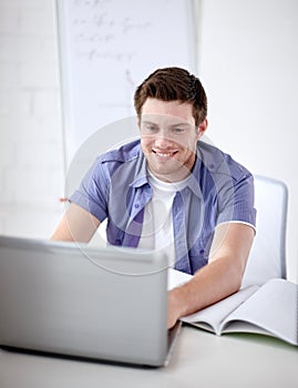 High school student with laptop in classroom