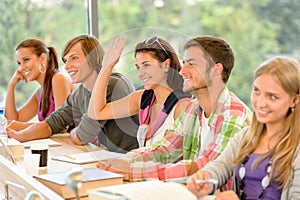 High-school student raising her hand in class