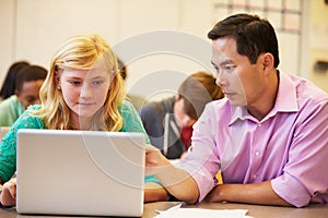 High School Student With Teacher In Class Using Laptop