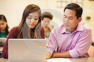 High School Student With Teacher In Class Using Laptop