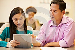 High School Student And Teacher Using Digital Tablet