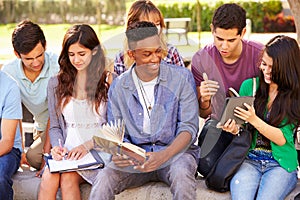 High School Students Collaborating On Project On Campus