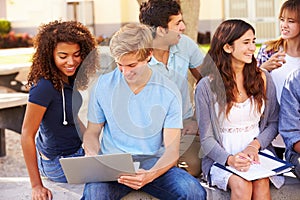 High School Students Collaborating On Project On Campus