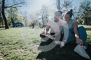 High school students collaborating on a project in a sunny park