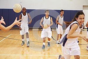 High School Students Playing Dodge Ball In Gym