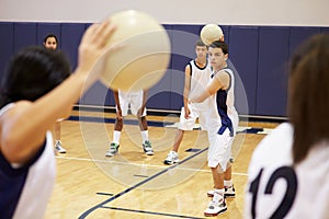 High School Students Playing Dodge Ball In Gym photo
