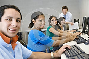 High School Students With Professor In Computer Class