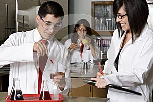 High School Students With Professor In Science Lab