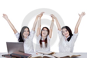 High school students raise hands together