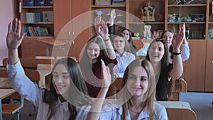 High school students stretch their hands in the lesson. Russian school.