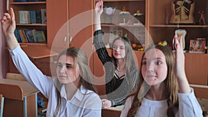 High school students stretch their hands in the lesson. Russian school.