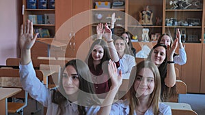 High school students stretch their hands in the lesson. Russian school.