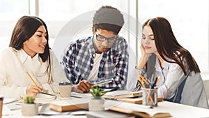 High school students studying and reading together in library