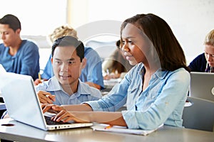 High School Students With Teacher In Class Using Laptops