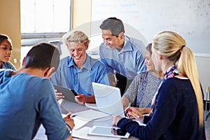 High School Students With Teacher In Class Using Laptops