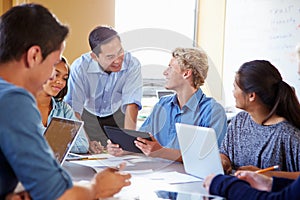 High School Students With Teacher In Class Using Laptops