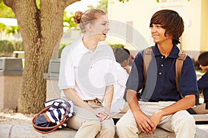 High School Students Wearing Uniforms On School Campus photo