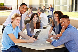 High School Students Working On Campus With Teacher